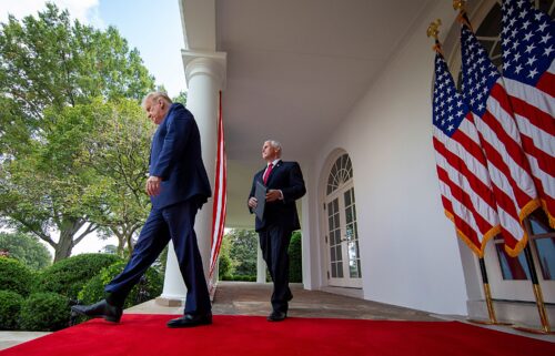 US President Donald Trump is followed by Vice President Mike Pence in the Rose Garden of the White House on September 28