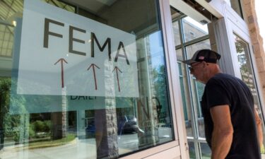 A resident enters a FEMA improvised station to attend claims by local residents affected by floods following the passing of Hurricane Helene