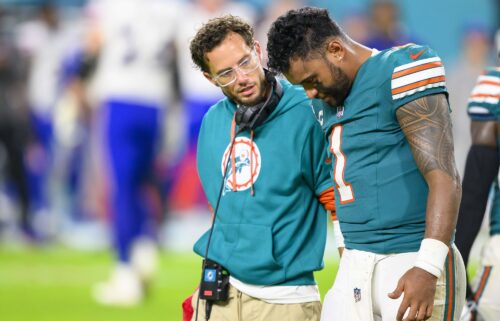 Miami Dolphins quarterback Tua Tagovailoa (right) walks off the field with head coach Mike McDaniel during the game against the Buffalo Bills.