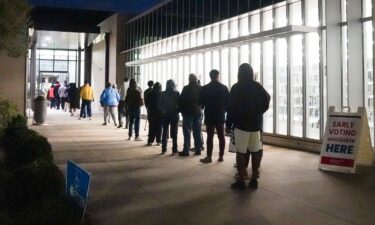 People stand in line at Metropolitan Library to cast their votes in the US presidential election on October 15 in Atlanta.