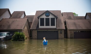 Jenna Fountain carries a bucket to recover items in Port Arthur