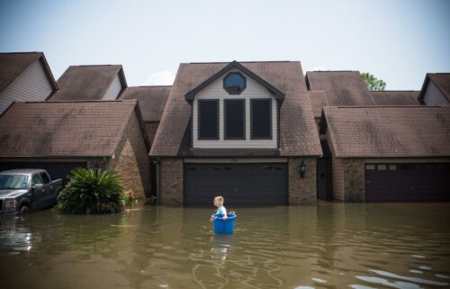 Jenna Fountain carries a bucket to recover items in Port Arthur